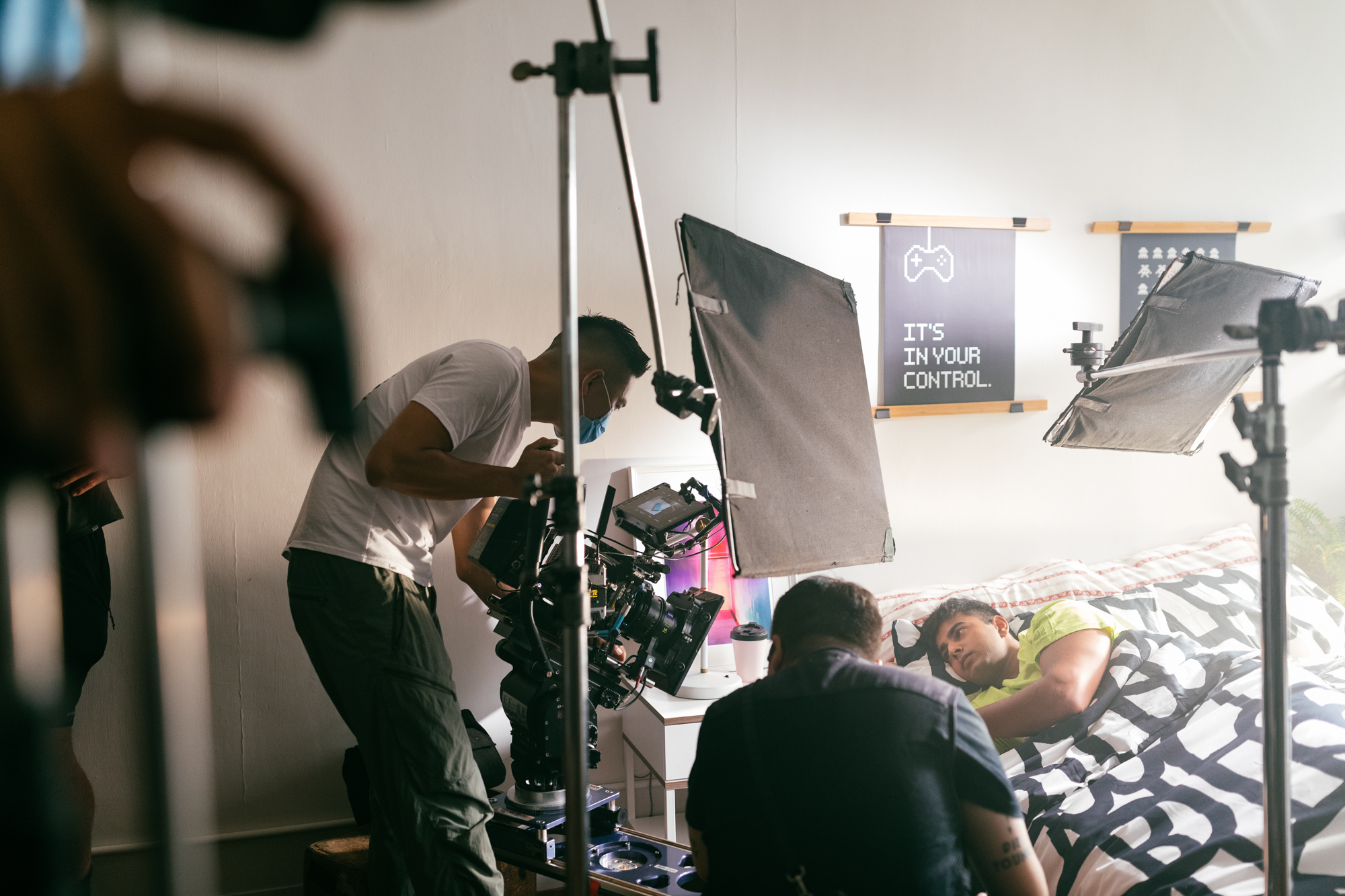 Photo studio for commercial filming in Hong Kong | workshop ten, Kennedy Town | Actor lying in bed surrounded by video camera and lighting equipment