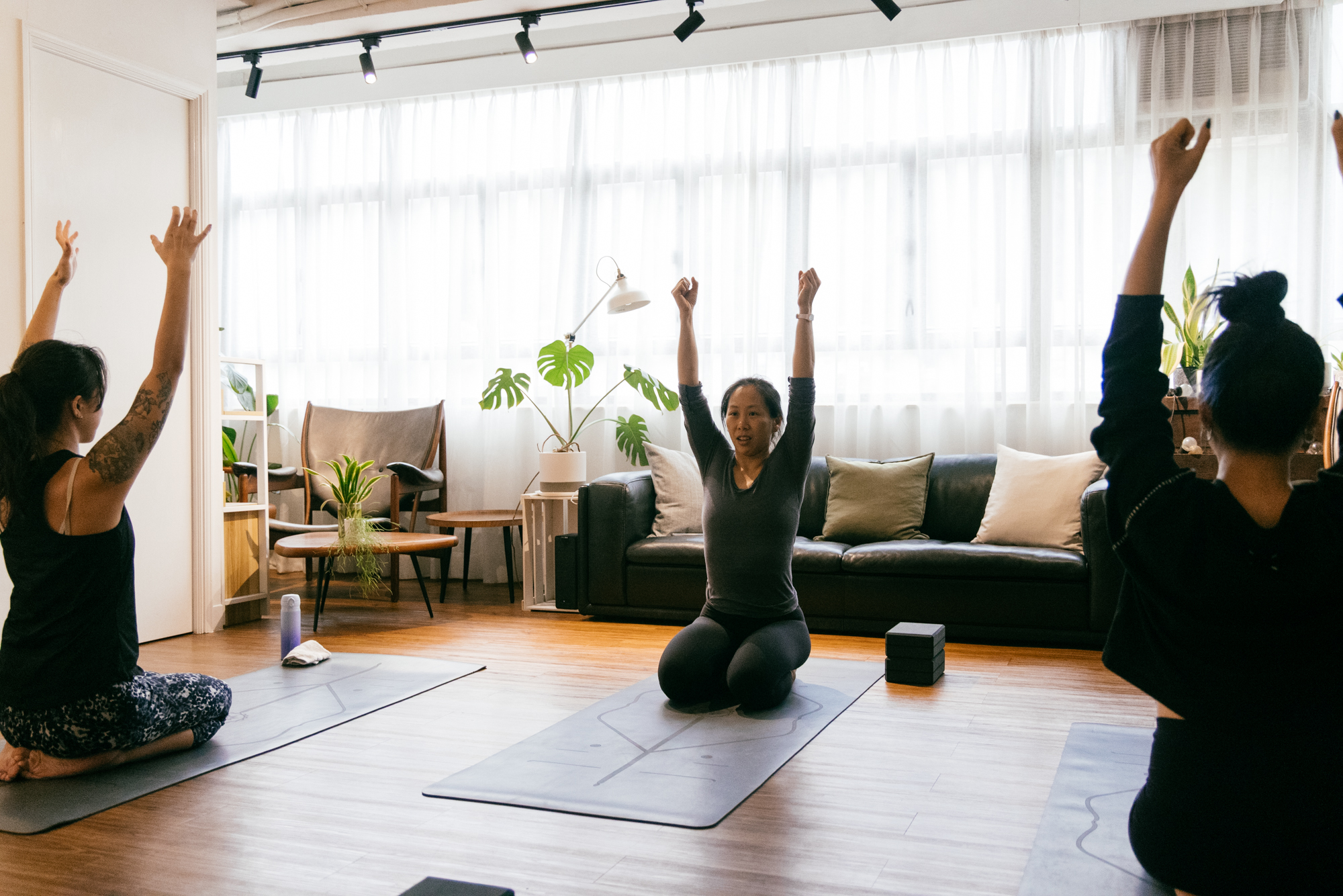 Vinyasa yoga class in Kennedy Town | A group class doing a twisting pose | workshop ten
